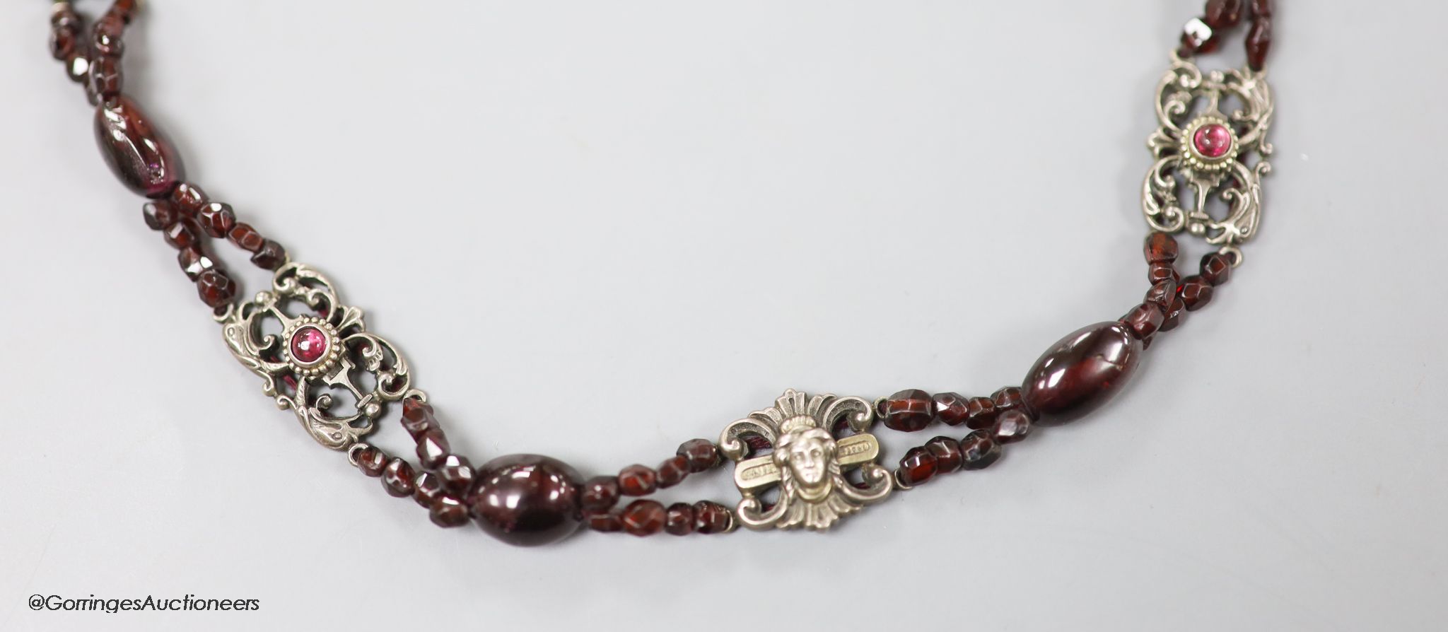 An early 20th century white metal, garnet and red paste? set choker necklace, 40cm.